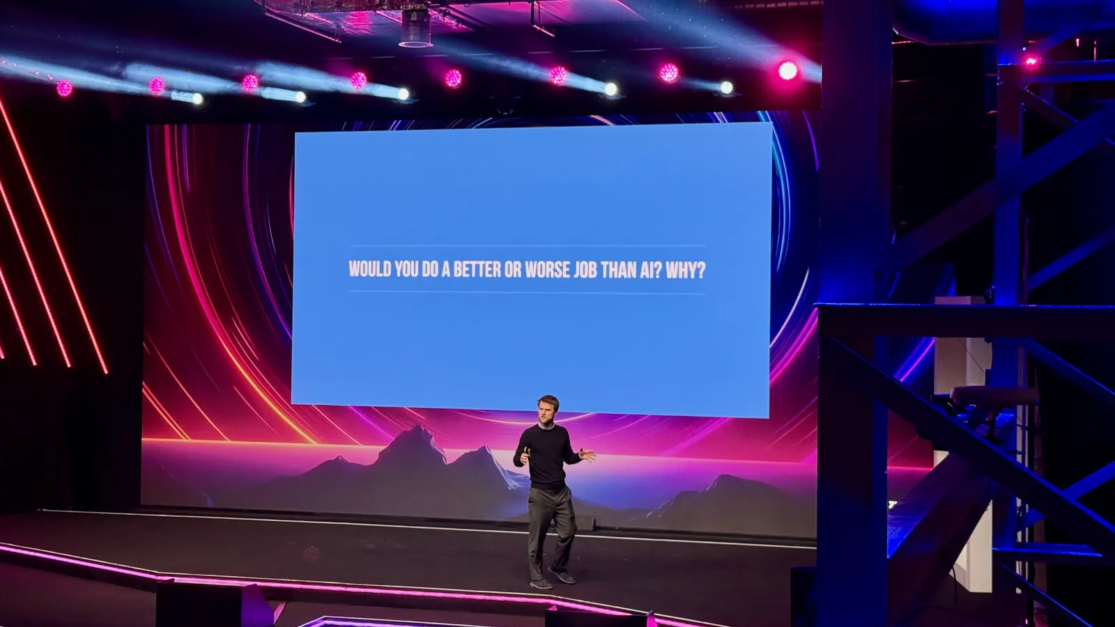 Jonnie Penn on the main stage, under a screen asking “Would you do a better or worse job than AI? Why?”
